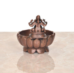 Copper Ganesha urli bowl, close view of base feet and central idol