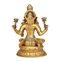 Brass Lakshmi statue back view, decorative halo behind head, seated on lotus