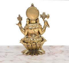 Back view of Lord Ganesha idol with round halo and raised arms over lotus base