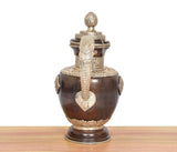 Dark brown brass teapot with vertical heart motif, banded neck details, and finial lid