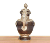 Dark brown brass teapot with vertical heart motif, banded neck details, and finial lid