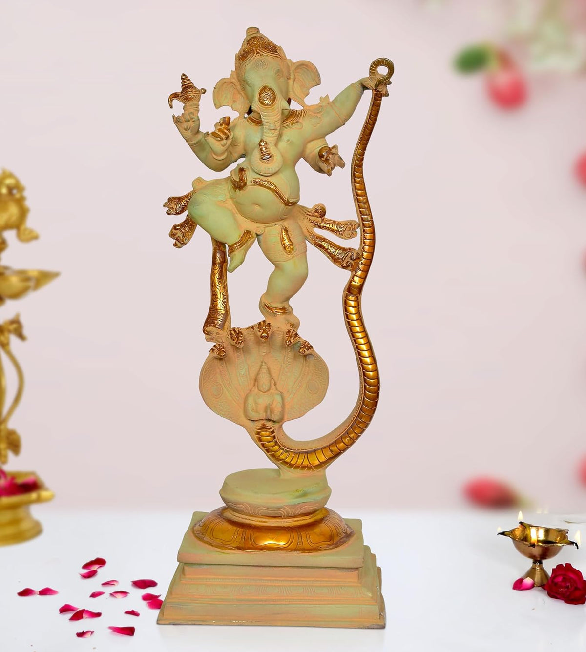 Brass Lord Ganesha dancing on Shesha Naag statue, raised arms, ornate detailing