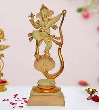 Brass Lord Ganesha dancing on Shesha Naag statue, raised arms, ornate detailing