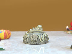 Brass charan paduka idol, side view with circular wheel emblem and U mark
