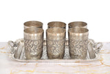 Six silver-toned engraved glasses in a matching tray, front view