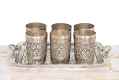 Six silver-toned engraved glasses in a matching tray, front view