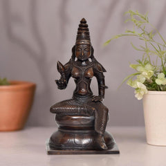 Bronze Parvati seated statue on pedestal, serene face and raised hands