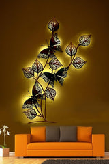 Iron leaf and butterfly wall decor with warm LED glow, black and gold cutout leaves