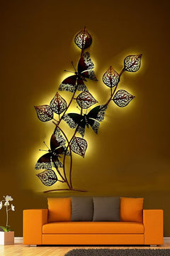 Iron leaf and butterfly wall decor with warm LED glow, black and gold cutout leaves