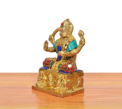 Brass Santoshi Maa statue side view, gold figure with teal shawl and red patterned belt