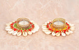 Two Diwali tea light holders with gold filigree bowl, cream shell border, red beaded garland