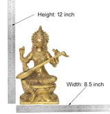 Brass Saraswati idol with height 12 in and width 8.5 in shown on measuring layout