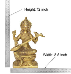 Brass Saraswati idol with height 12 in and width 8.5 in shown on measuring layout