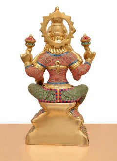 Back view of Lakshmi brass idol, carved backplate and multicolor dress details