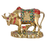 Brass cow statue with calf, red-and-green embroidered look cloth, blue bead trim