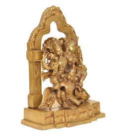 Rear/side view of gold brass Lakshmi-Narayana on Garuda with ornate back frame