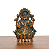 Multicolour brass Lord Ganesha idol, back view with halo-like arch and carved ornaments