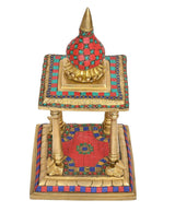 Top view brass pooja mandir showing teal patterned dome and tiered gold base