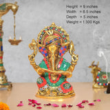 Metal Ganesha idol, height 9 in; colorful crown and outfit holding a scroll
