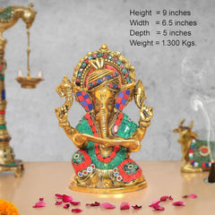 Metal Ganesha idol, height 9 in; colorful crown and outfit holding a scroll