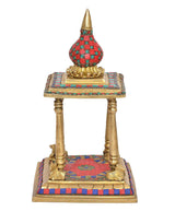 Brass pooja mandir with red-and-teal rounded top, gold base, and decorated platforms