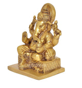 Brass Ganesha statue seated on square pedestal, textured garments, 7 inch height