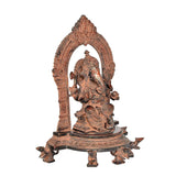 Brass Ganesh seated side profile with raised halo arch and detailed ornamentation