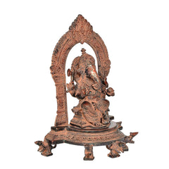 Brass Ganesh seated side profile with raised halo arch and detailed ornamentation