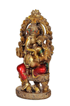 Resin Ganesha idol, side view with trunk and raised hand, red dhoti, ornate base