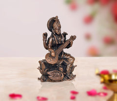 Copper-toned bronze Saraswati Maa statue, seated playing veena, front view