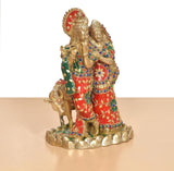 Dreiviertelansicht Radha-Krishna Messingidol mit Kuh, rotes Gewand mit grünen Akzenten