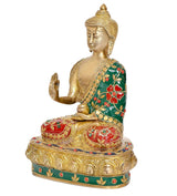 Brass Buddha statue, side view with raised palm, green robe and red jeweled detailing