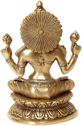 Brass Lakshmi idol back view, flower-like halo and detailed drapery on lotus base.