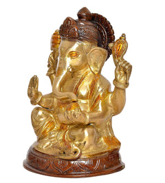 Brass Ganesha idol from side angle, seated with raised hands, ornate brown details