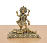 Mahakaali idol front view, arms raised, detailed brass ornaments and seated pose