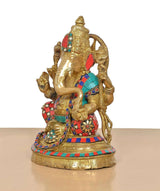 Brass Lord Ganesha idol side view with trunk, detailed hands, and colorful patterned garments.