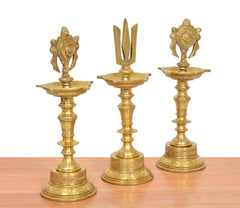 Golden brass diya shankh oil lamps with chakra finial and ornate base sections