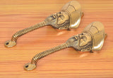 Man-face brass door handles with long flexible stems, gold-toned finish pair