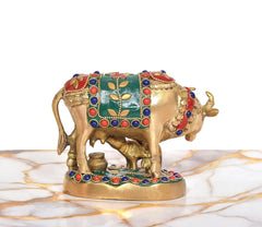 Brass cow figurine with calf, front-left angle; red headpiece, blue beads, gold base
