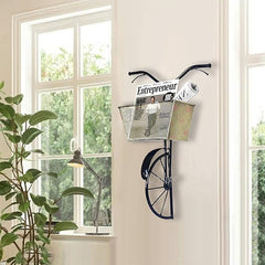 Black iron wall hanging basket holding stacked newspaper print in cream mesh bin
