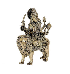 Durga Maa brass statue on lion, raised hands holding items, angled view