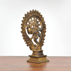 Copper Natraja Shiva idol angled view, dancing pose on square pedestal