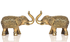 Brass elephant figurines, front view of 2 elephants facing each other with raised trunks