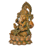 Brass Ganesha idol side view, curved trunk and hands in symbolic poses