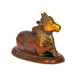 Brass Nandi bull statue, side profile view with decorative saddle and textured base