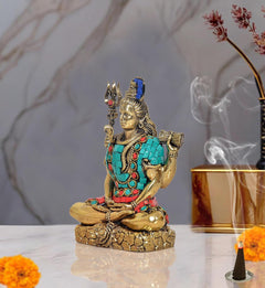 Brass Shiva idol sculpture side profile, turquoise torso with red belt and bead details