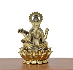 Brass Maa Saraswati statue back view, lotus petals base with raised hands