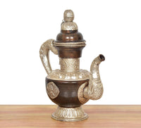 Brass tea kettle decor with curved handle, silver spout ends, and decorative base