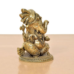 Brass Lord Ganesha idol, kneeling pose with raised hand and decorated clothing