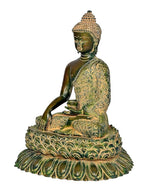 Brass Buddha statue in meditation, gold patterned robe over green lotus base